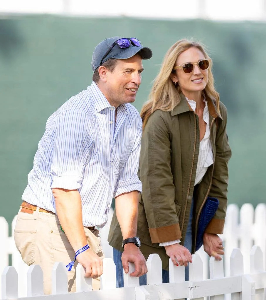 Peter and Harriet leaning on white fence