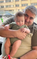 An undated provided photo of Gilbert Bernal with his grandchild.