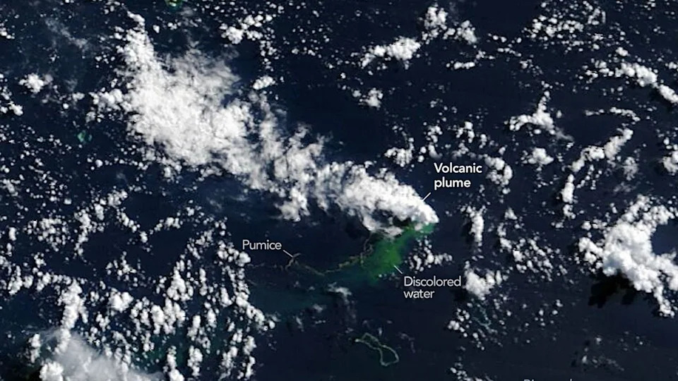 An aerial view of the Earth, showing where the volcanic plume is and an area of discolored water.