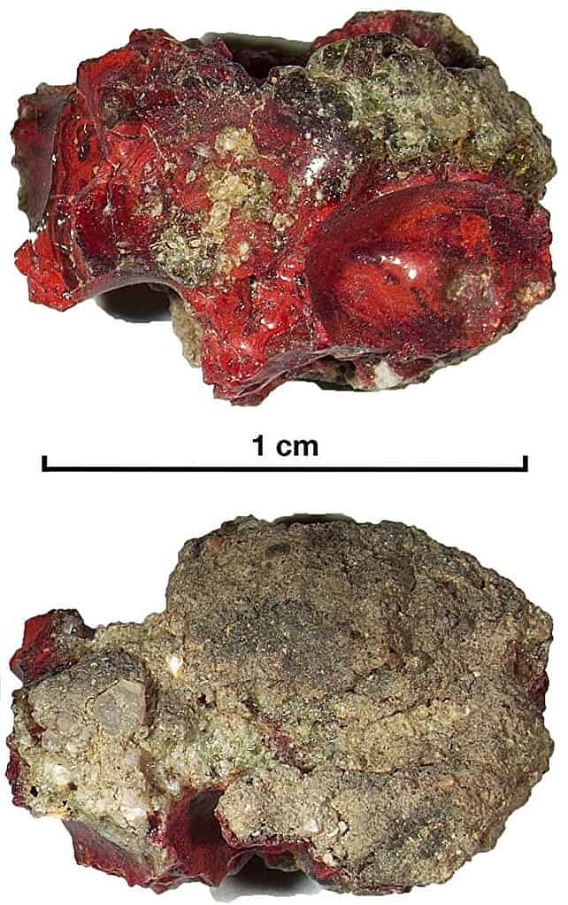Red trinitite sample from desert sand at the Trinity test site.