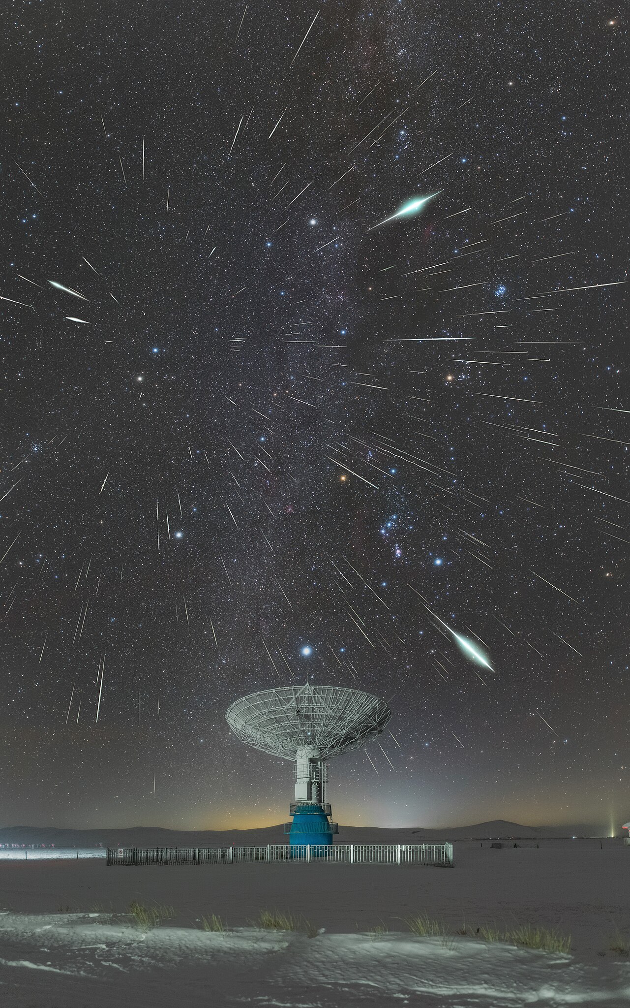 A telescope with a bright night sky, filled with meteors moving out from a radial point.