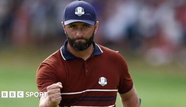 Golfer Jon Rahm clenching his fist at the Ryder Cup in 2025