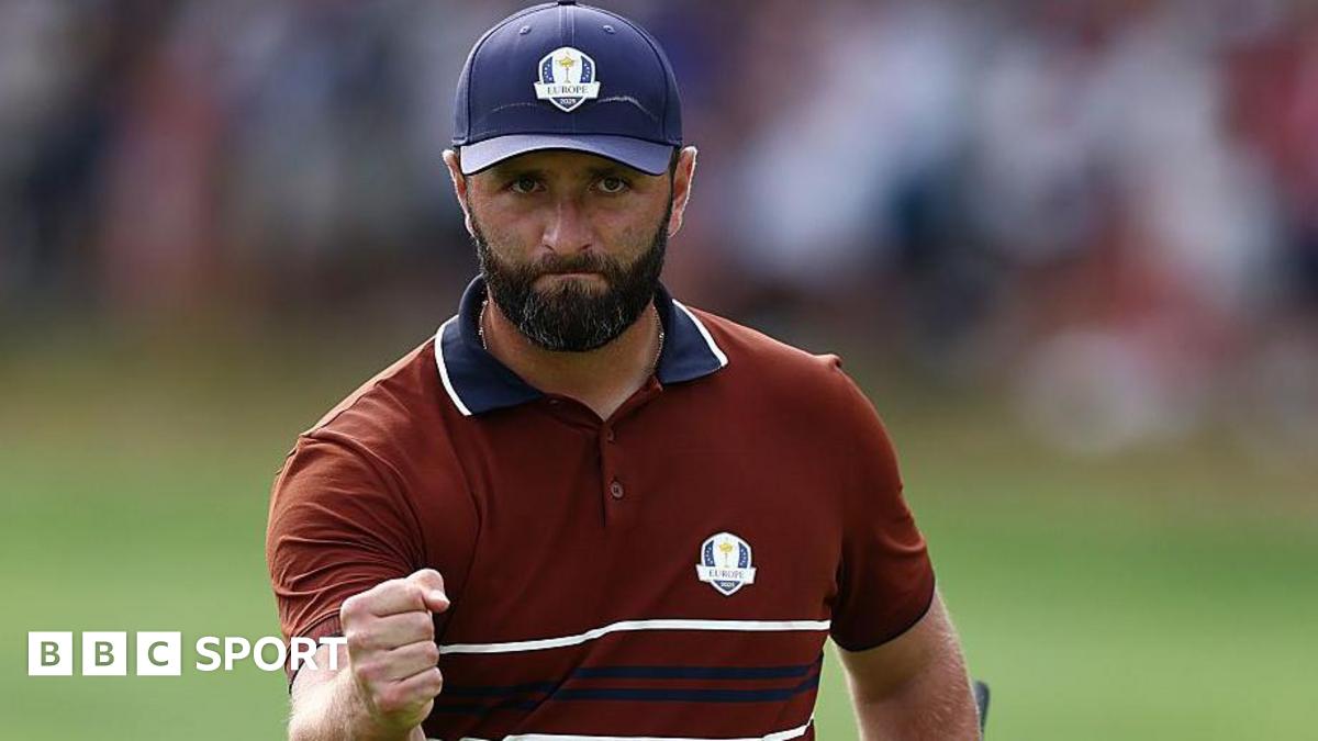 Golfer Jon Rahm clenching his fist at the Ryder Cup in 2025