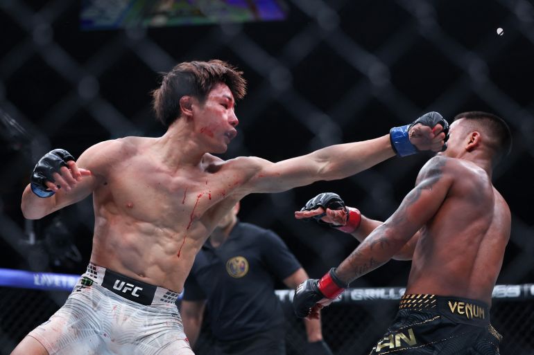 NEWARK, NEW JERSEY - MAY 09: Tatsuro Taira of Japan, (L), punches Joshua Van of Myannmar in a flyweight title bout during UFC 328 at the Prudential Center on May 09, 2026 in Newark, New Jersey. Ishika Samant/Getty Images/AFP (Photo by Ishika Samant / GETTY IMAGES NORTH AMERICA / Getty Images via AFP)