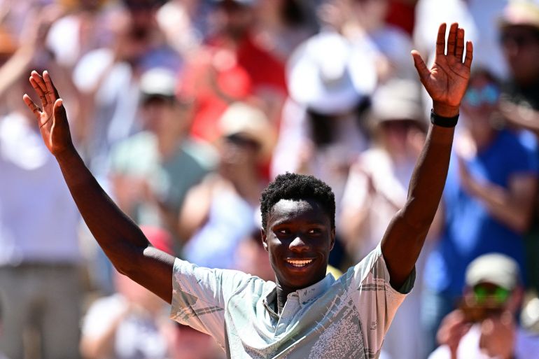 France's Moise Kouame celebrates his victory over Croatia's Marin Cilic during their men's singles match on day 3 of the French Open tennis tournament on Court Simonne-Mathieu at the Roland-Garros 