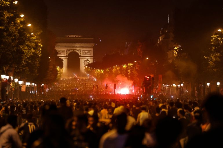 PSG supporters gather on the Champs-Elysees Avenue after the club won the UEFA Champions League final between Paris Saint-Germain (PSG) and Arsenal FC played in Budapest, in Paris on May 30, 2026. (Photo by ROMEO BOETZLE / AFP)