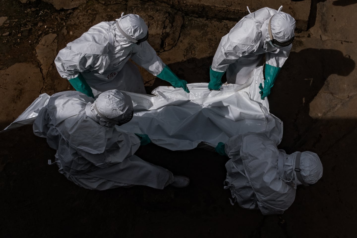 Workers from the Uganda Red Cross Society evacuate the body of a suspected Ebola victim in Kampala, Uganda on May 26.