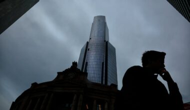 A pedestrian passes South Station Tower during the morning commute in Boston on July 2, 2025.