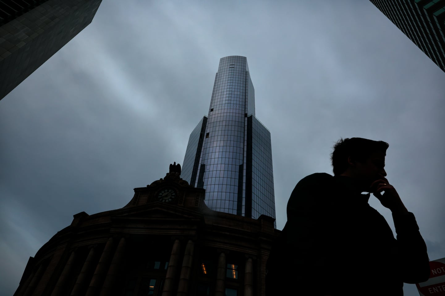 A pedestrian passes South Station Tower during the morning commute in Boston on July 2, 2025.