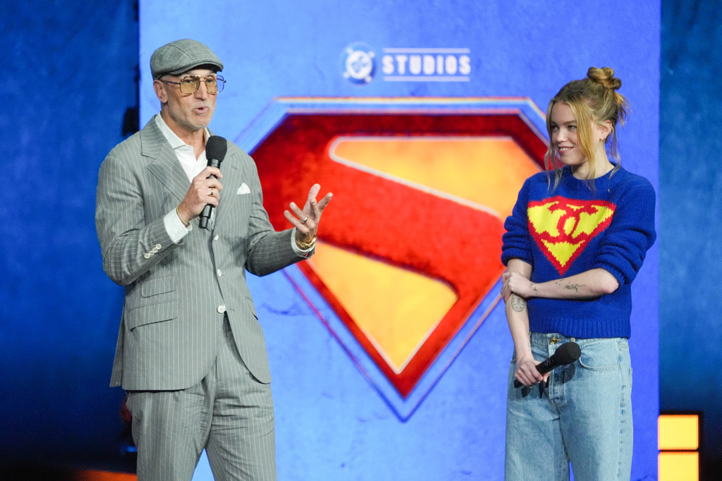 Director Craig Gillespie, left, and cast member Millie Alcock of the upcoming film "Supergirl" speak during the Warner Bros. presentation at CinemaCon on Tuesday, April 14, 2026, at Caesars Palace in Las Vegas. (AP Photo/Chris Pizzello)
