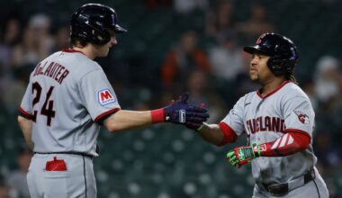 Cincinnati Reds' Matt McLain (9) and Gavin Lux (2) celebrate after McLain scored in the third inning of a baseball game against the Chicago Cubs, Saturday, Sept. 20, 2025, in Cincinnati.