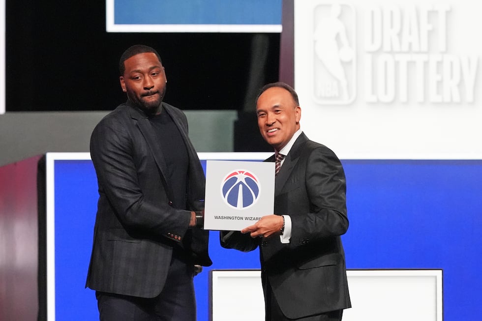 Washington Wizards' John Wall, left, and NBA Deputy Commissioner Mark Tatum, pose for photos...