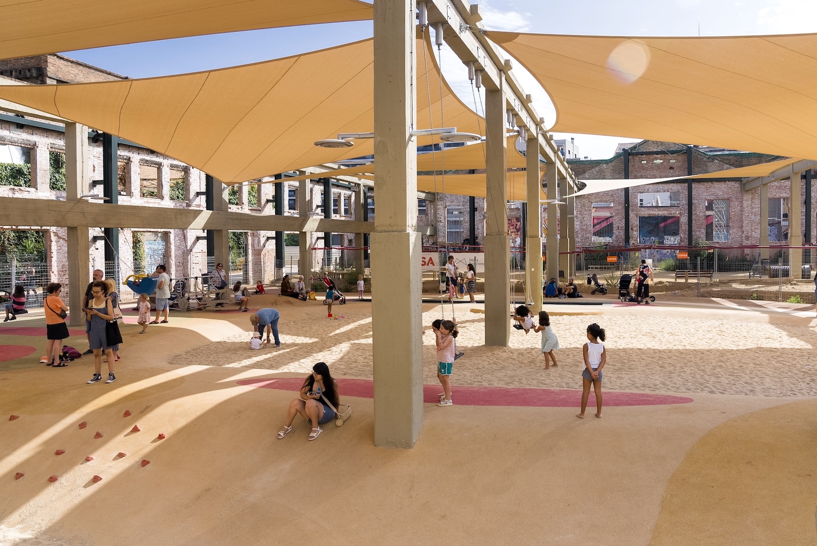 kids play on a playground with sun shades in Barcelona
