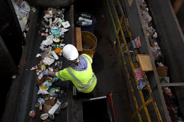 A worker sorts through recyclable materials at Recology's Recycle Central on Sept. 24, 2024 in San Francisco, California. California Attorney General Rob Bonta sued ExxonMobil, alleging the oil and gas corporation misled consumers by telling them that recycling was a viable solution for plastic waste. (Justin Sullivan/Getty)