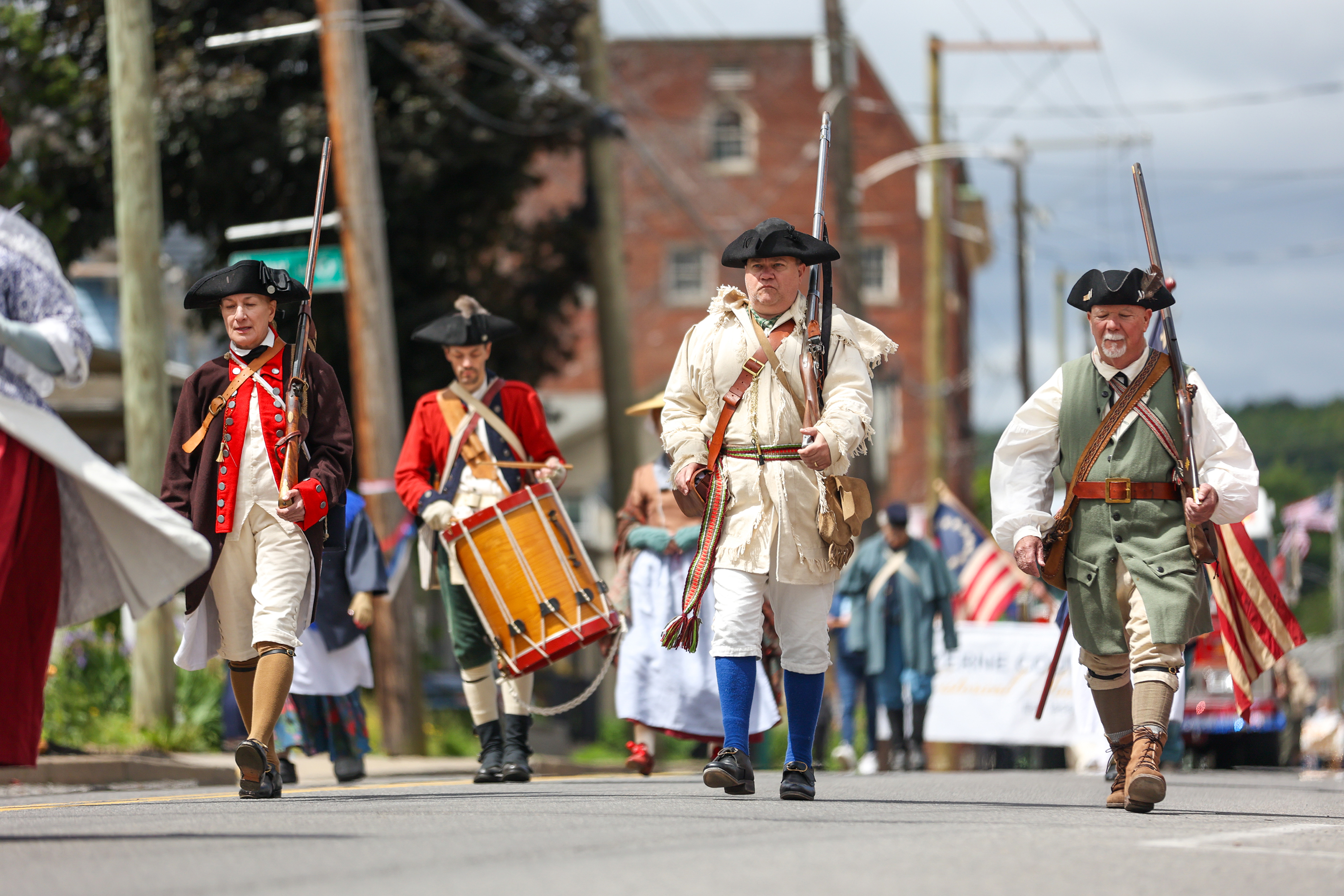 Members of the 24th Connecticut Militia Regiment march during a...