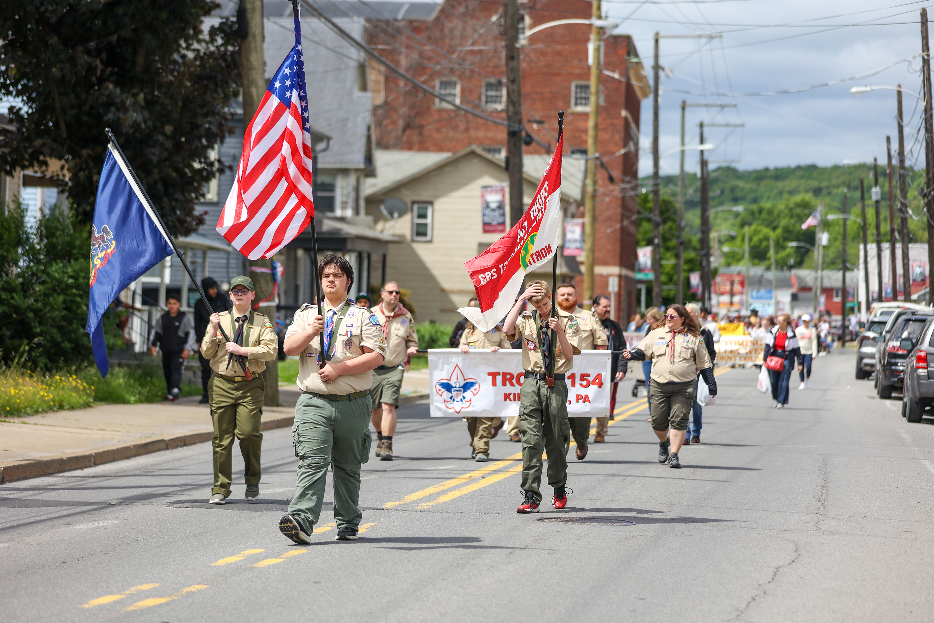 Members of the Boy Scout Troop 154 march during a...