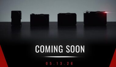 Four silhouetted cameras on a dark background, with one emitting a small red light. Text below reads "COMING SOON" and "05.13.26" in white and red on a black and red gradient background.