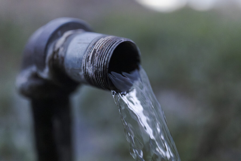 Water from a natural spring pours out of a pipe in the town of San Luis in the San Luis Valley of Colorado. Credit: Jacob Spetzler/Inside Climate News
