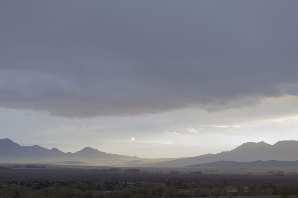 The sun sets over agriculture fields in San Luis, Colorado on Tuesday, May 5, 2026. The Rio Grande recharges the aquifer, which is the source of water for the entire San Luis Valley, including its agriculture, which is the industry which economically sustains the area. The amount of water necessary for large scale agriculture is also the primary reason for the aquifer’s depletion. Credit: Jacob Spetzler/Special to Inside Climate News