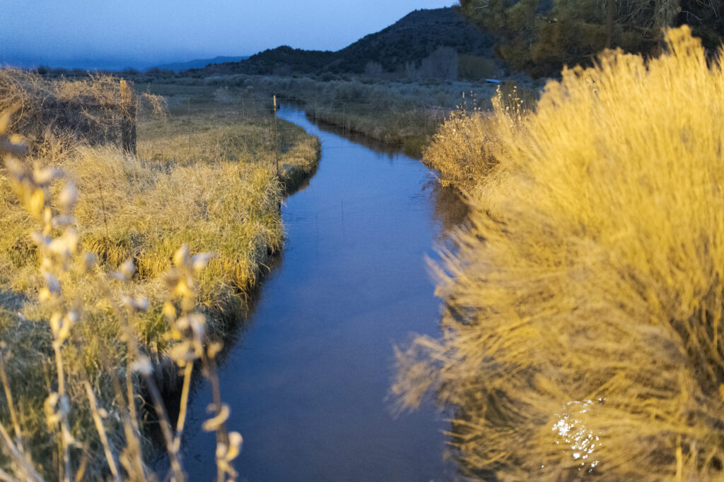 An acequia, a traditional community-managed irrigation ditch that channels water from rivers and streams to farms and towns, flows into San Luis, Colorado. Credit: Jacob Spetzler/Inside Climate News