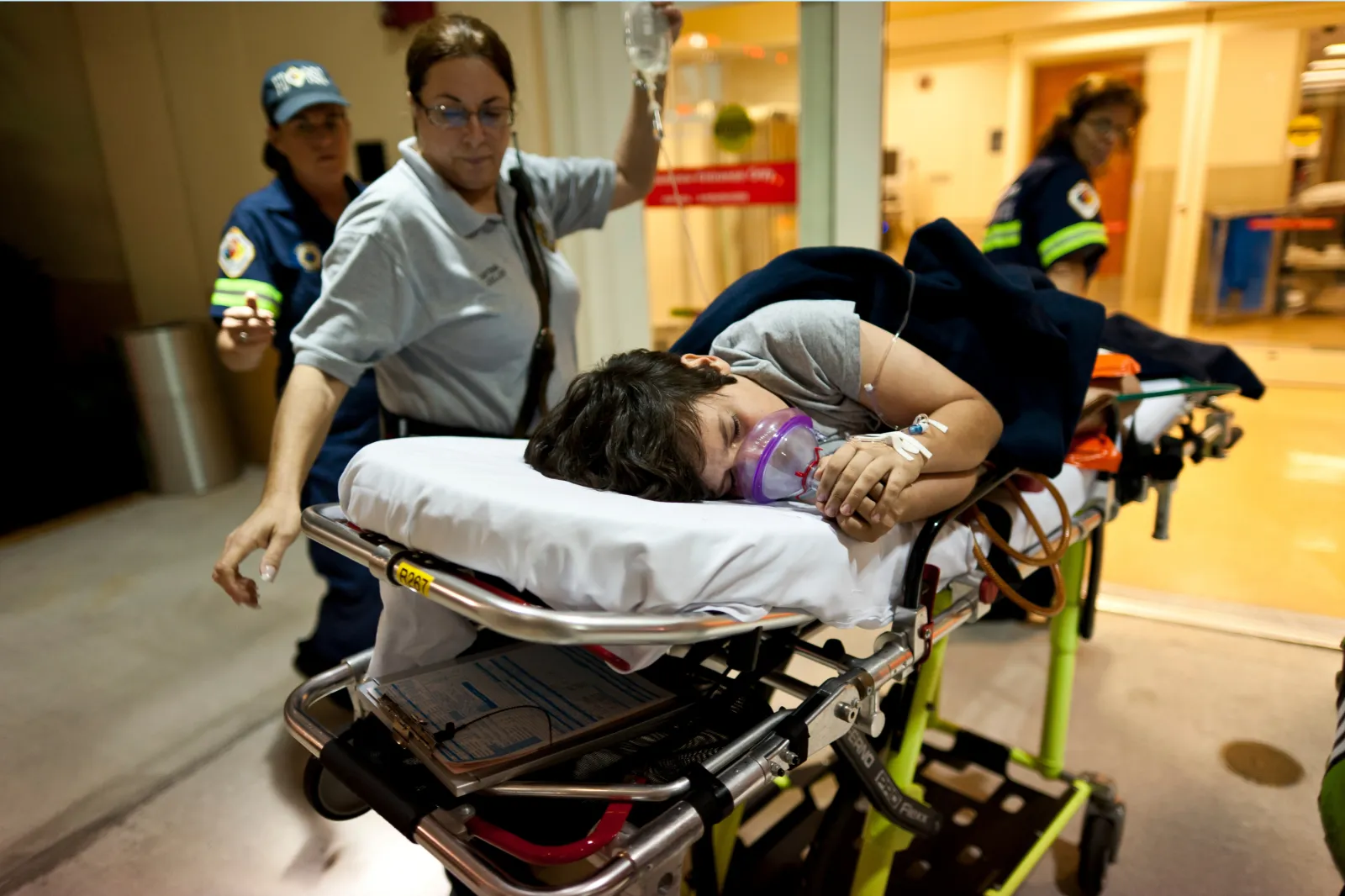 A child in emergency room, with an oxygen mask.