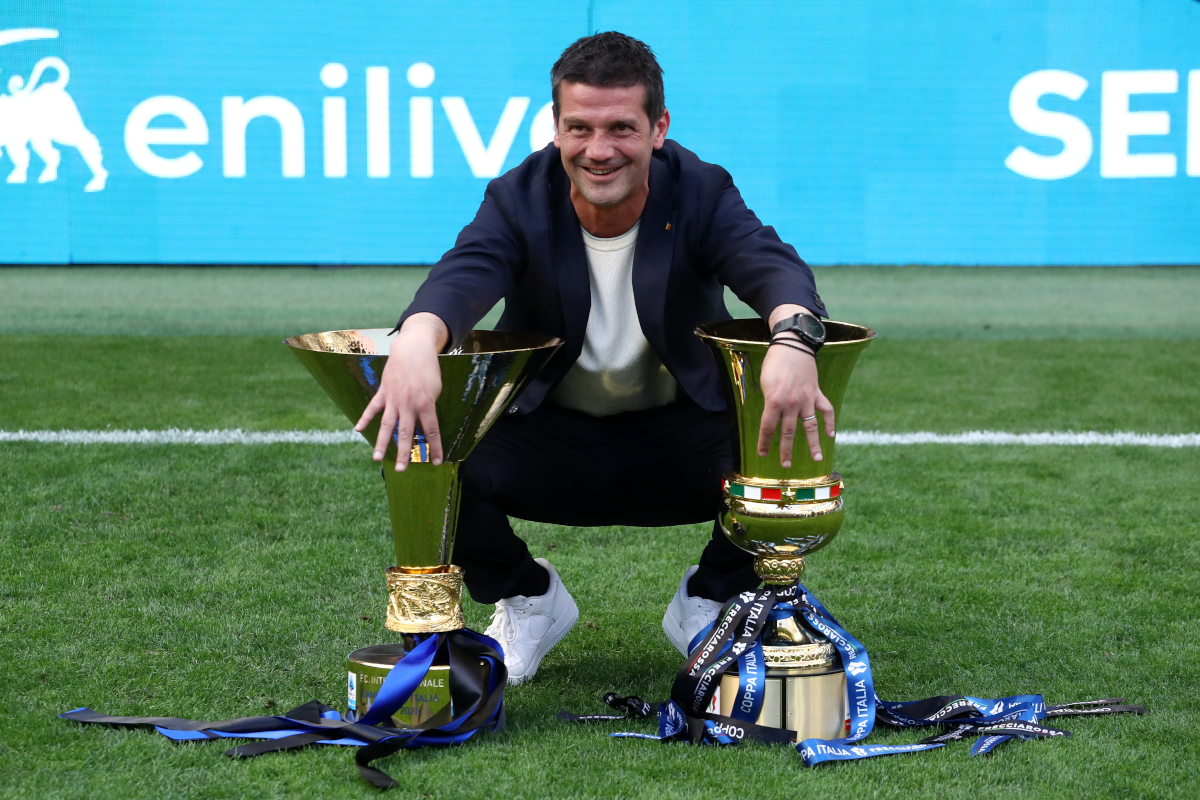 MILAN, ITALY - MAY 17: Cristian Chivu, Head Coach of FC Internazionale Milano, poses for a photo with the Coppa Campioni d'Italia and Coppa Italia trophies following the Serie A match between FC Internazionale and Hellas Verona FC at Giuseppe Meazza Stadium on May 17, 2026 in Milan, Italy. (Photo by Marco Luzzani/Getty Images)