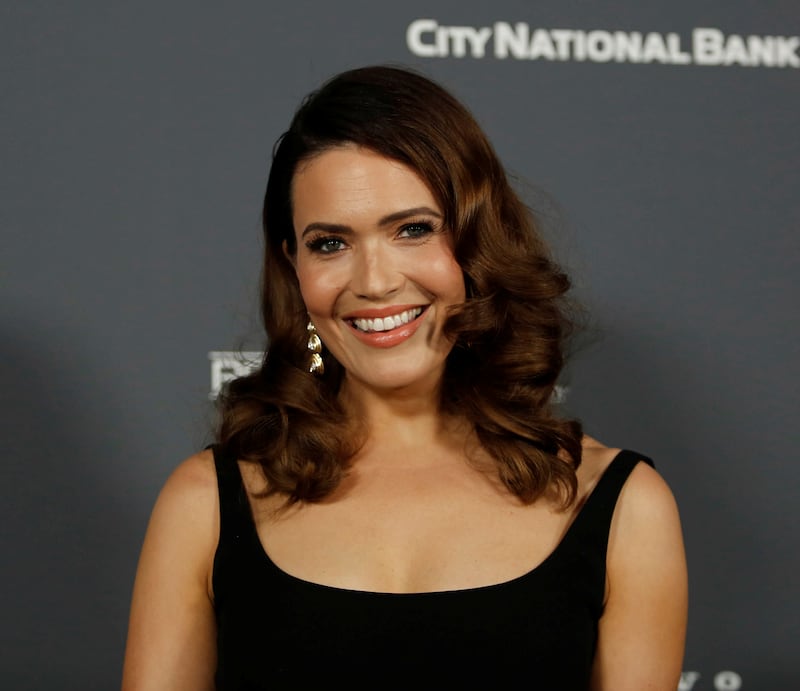 Mandy Moore attends the Baby2Baby 10-Year Gala with dark brown hair and a black dress at the Pacific Design Center in 2021.
