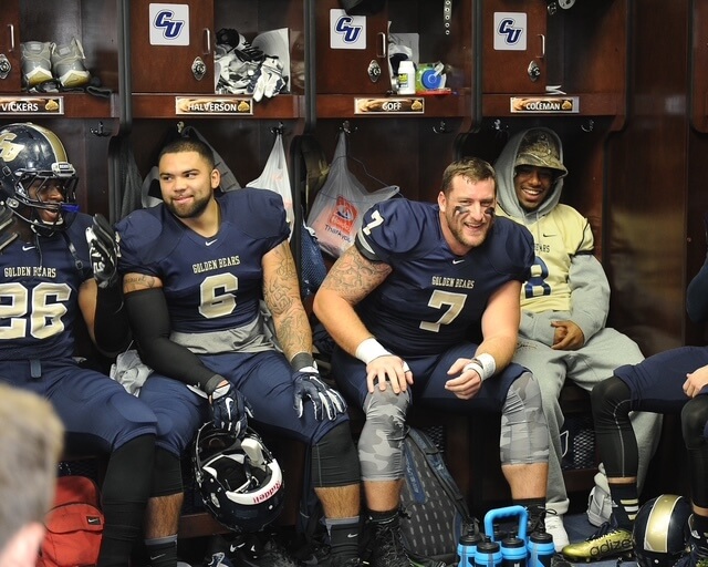 Jourdan Halverson with teammates in the Concordia University-St. Paul locker room.