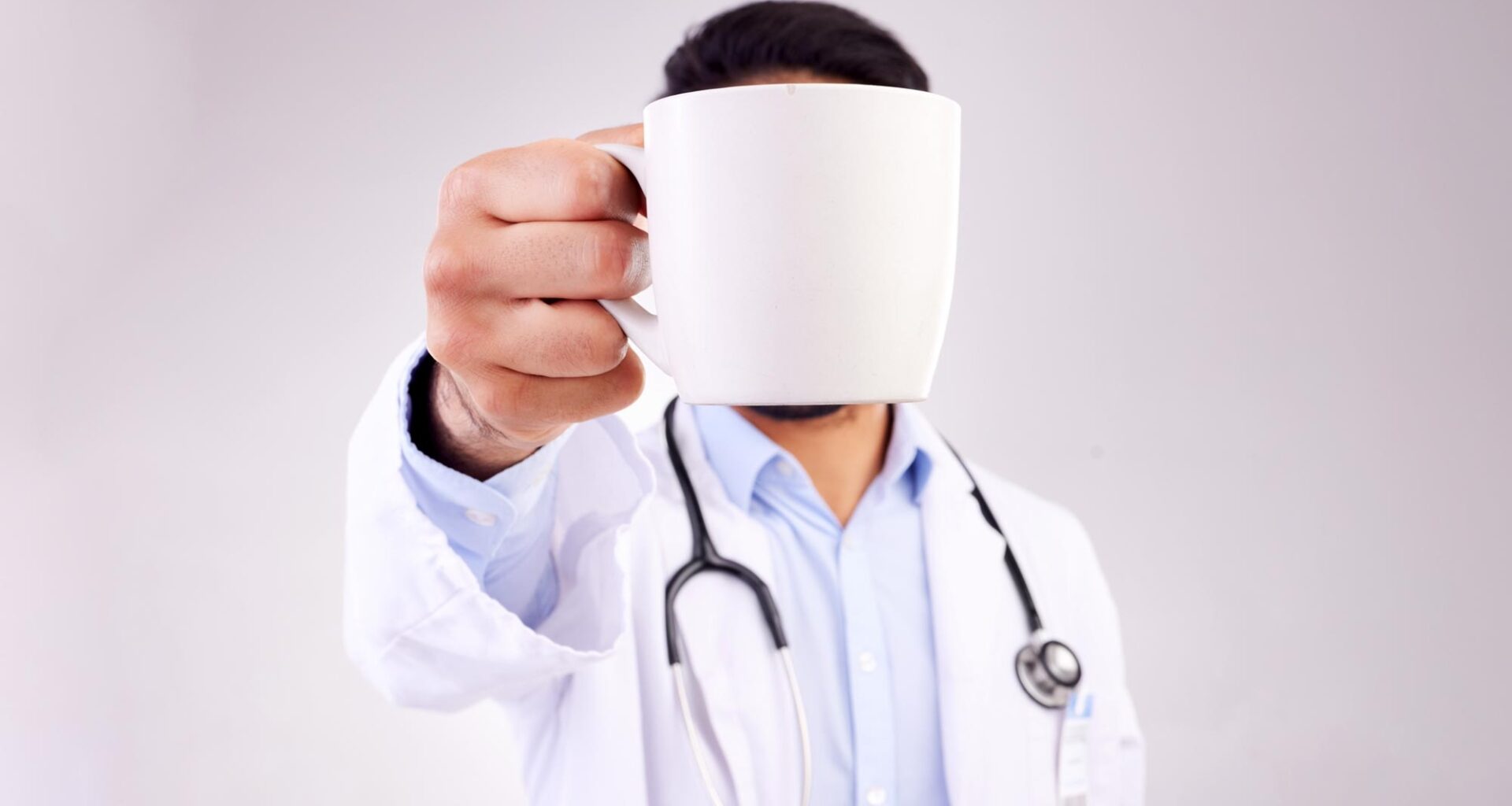Doctor Holding Coffee Mug High