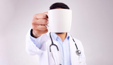 Doctor Holding Coffee Mug High