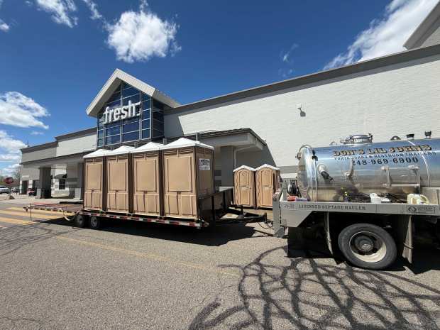 Portable toilets were being set up at the Meijer on Adams Road in Rochester Hills on Sunday, May 10, as the city has requested residents and businesses reduce water use. (Stephen Frye / MediaNews Group)
