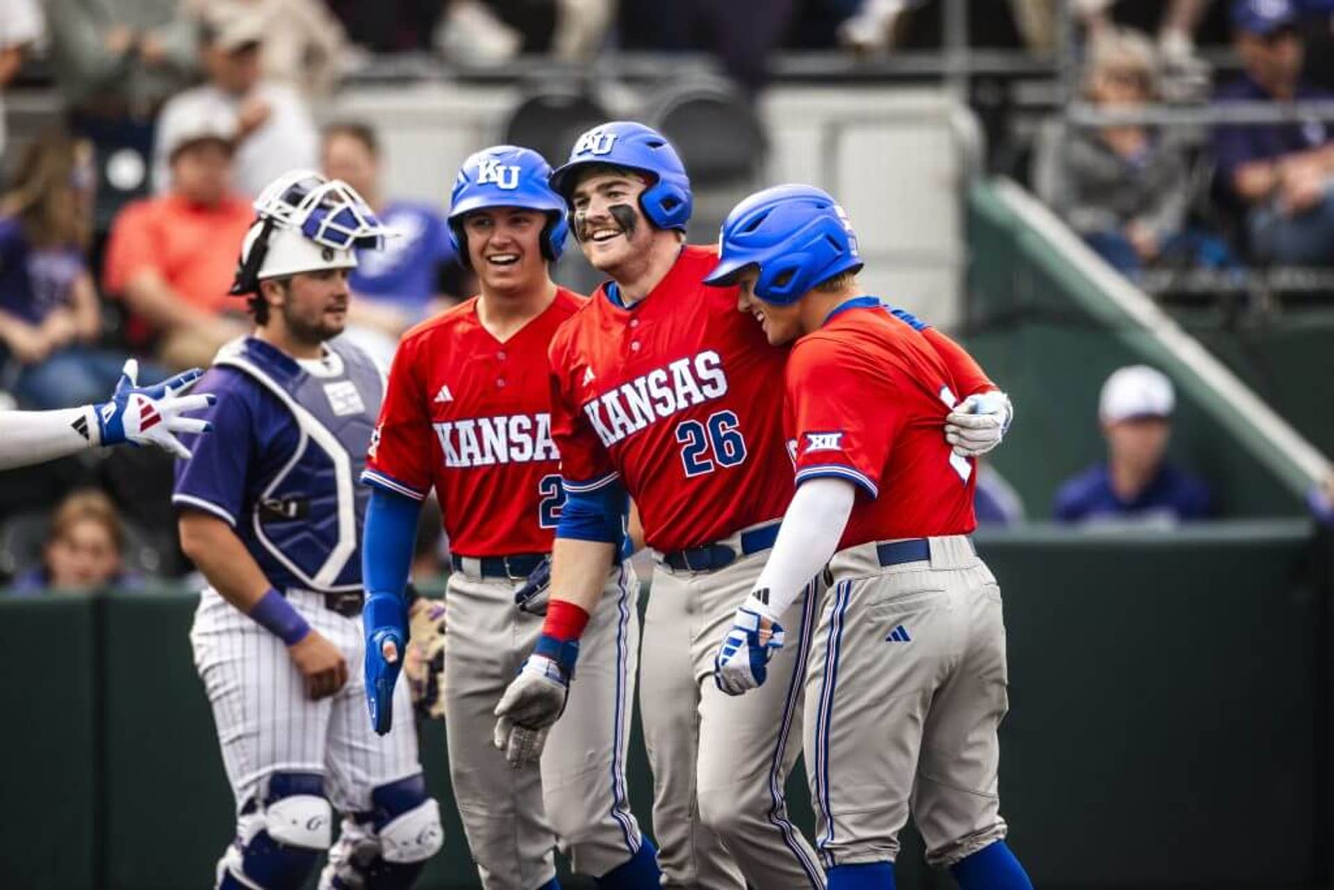 Kansas baseball players celebrate against Kansas State.