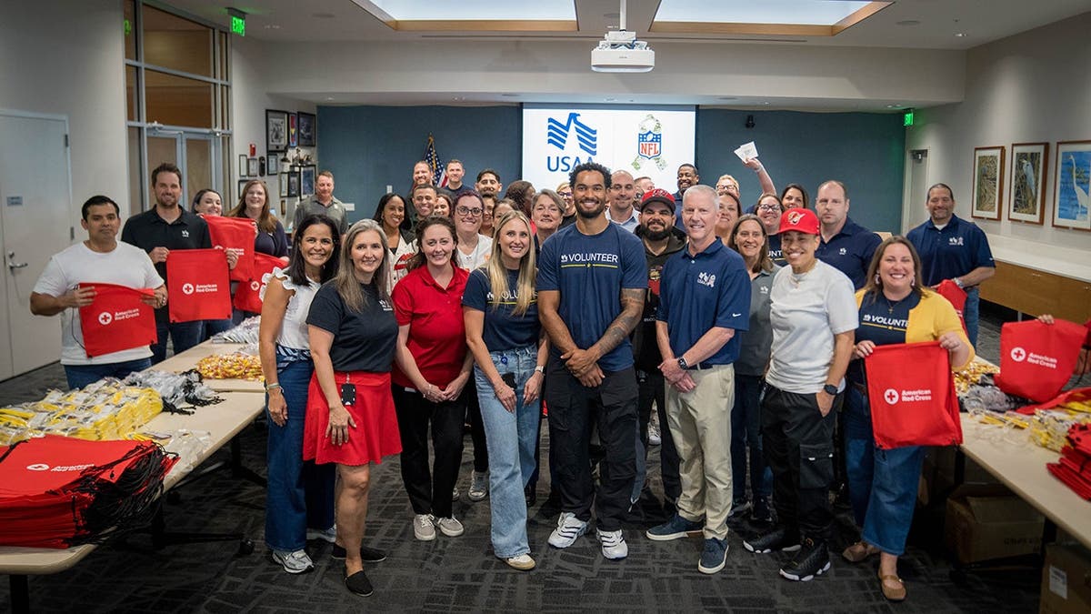 Emeka Egbuka with USAA volunteers