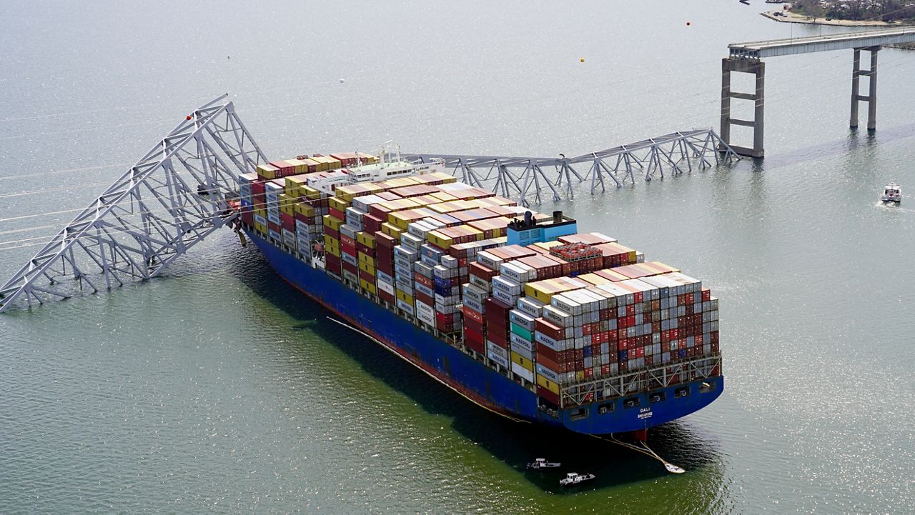 In this photo provided by the Maryland National Guard, the cargo ship Dali is stuck under part of the structure of the Francis Scott Key Bridge after the ship hit the bridge March 26, 2024, in Baltimore. (Maryland National Guard via AP, File)