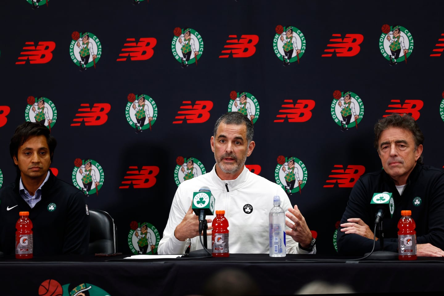 Aditya Mittal (left) and Wyc Grousbeck (right) flanked Bill Chisholm at a press conference following the sale of the Celtics.