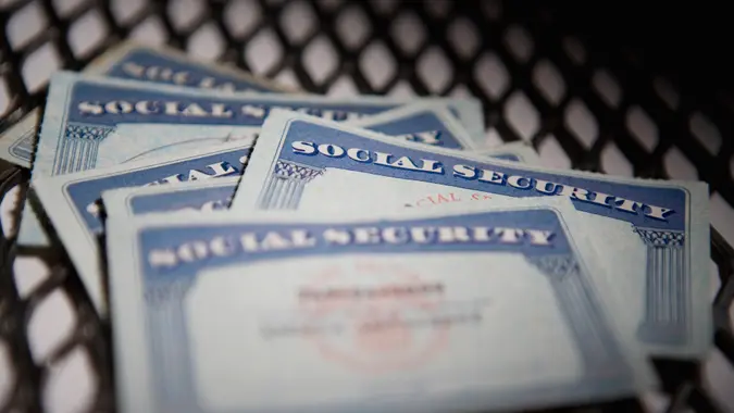american culture, authority, chain-link fence, close-up, color image, group of objects, ideas, identity, indoors, nobody, photography, protection, safety, security, selective focus, social security card, text, western script, capital letter, horizontal