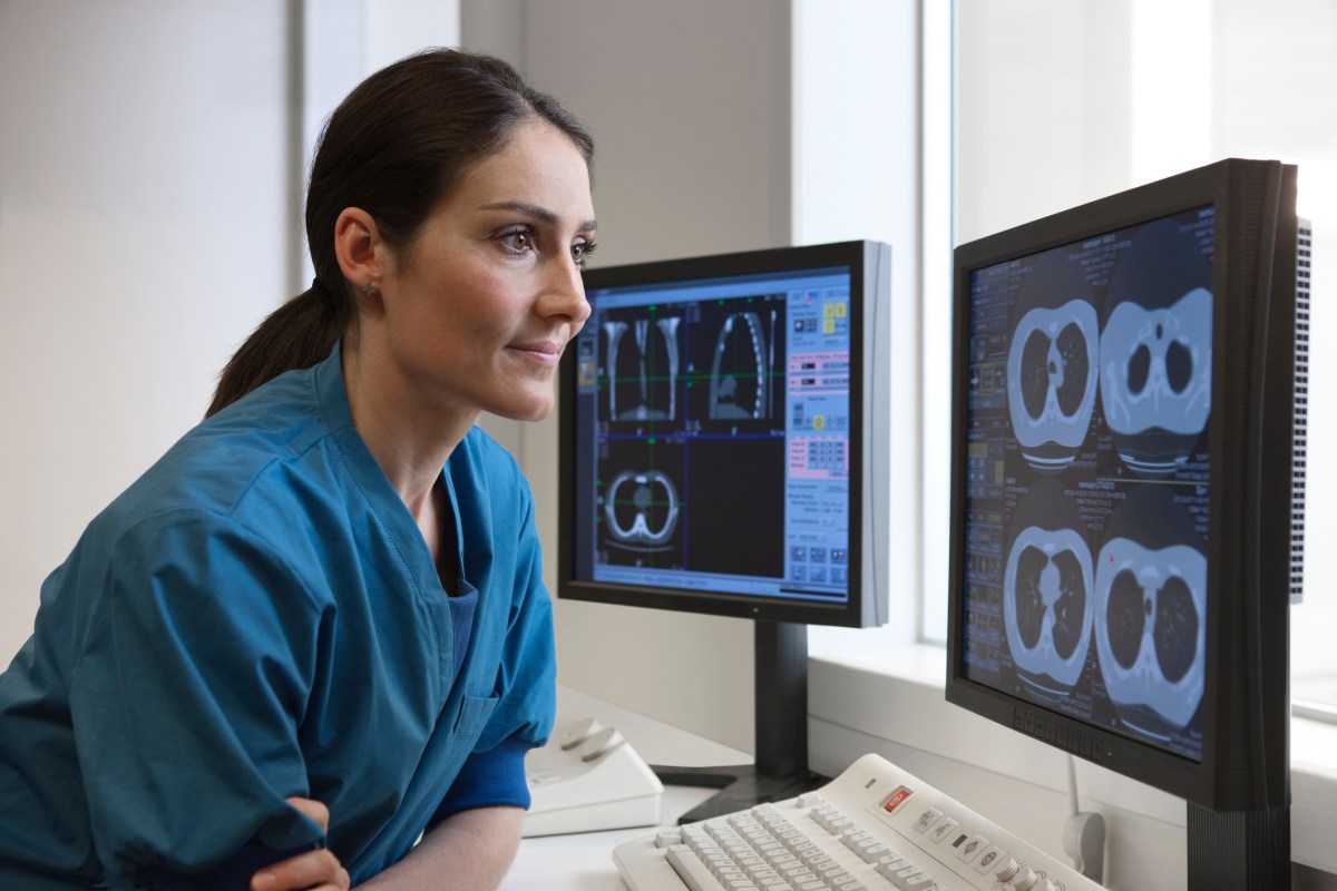 Doctor looking at x-rays from CT-scanner on computer