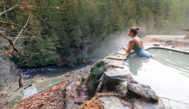 Woman with blue swimsuit relaxing in a hot pool in autumn, Umpqua Hot Springs, Douglas county, Oregon, United States