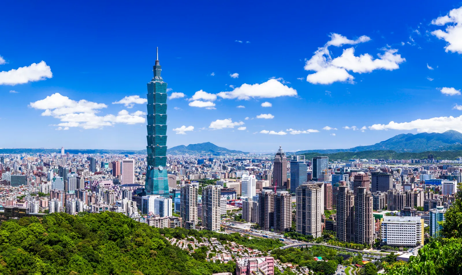 Panoramic view of the Taipei skyline in Taiwan, with the Taipei 101 skyscraper at its center.