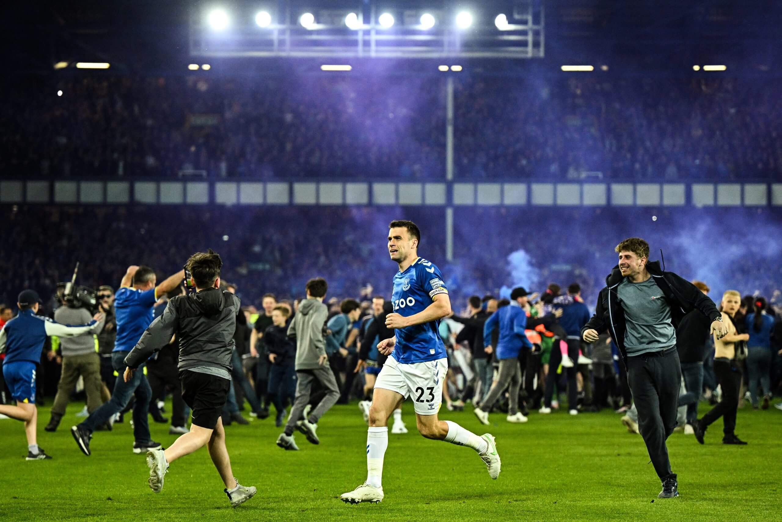 Seamus Coleman as Everton supporters invade the pitch after the team's memorable survival in 2022