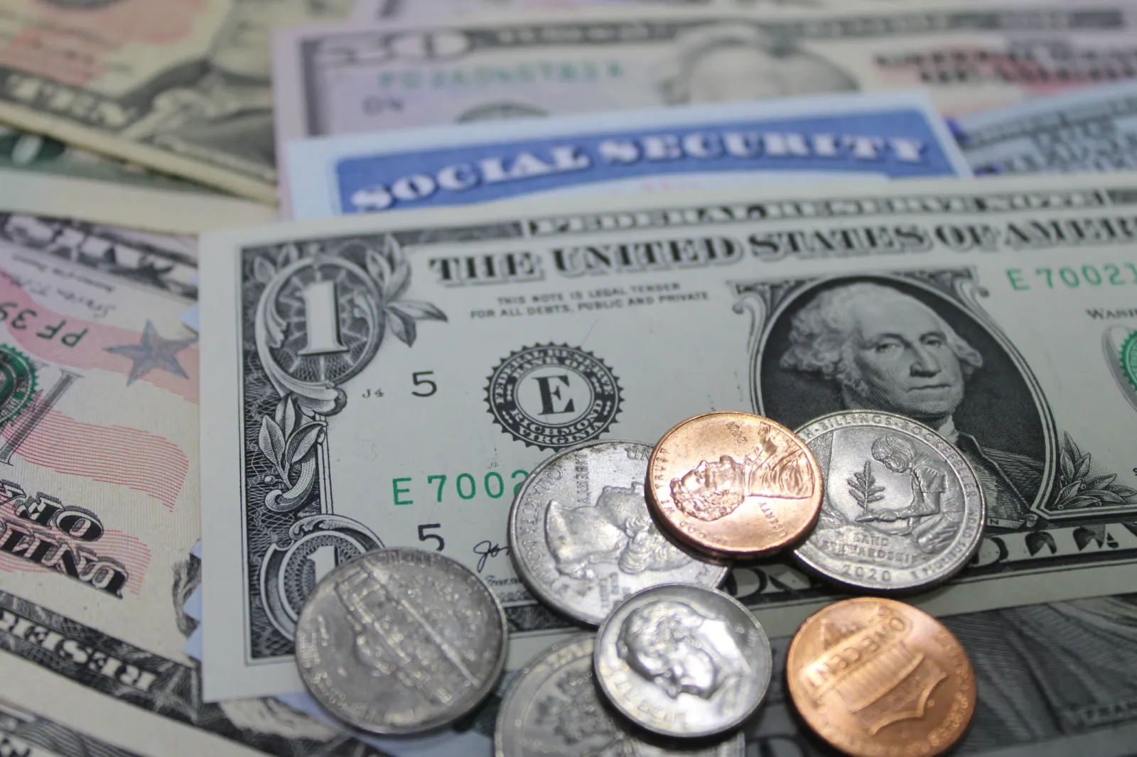 Stock image/file photo: Social Security card with U.S. dollar bills.