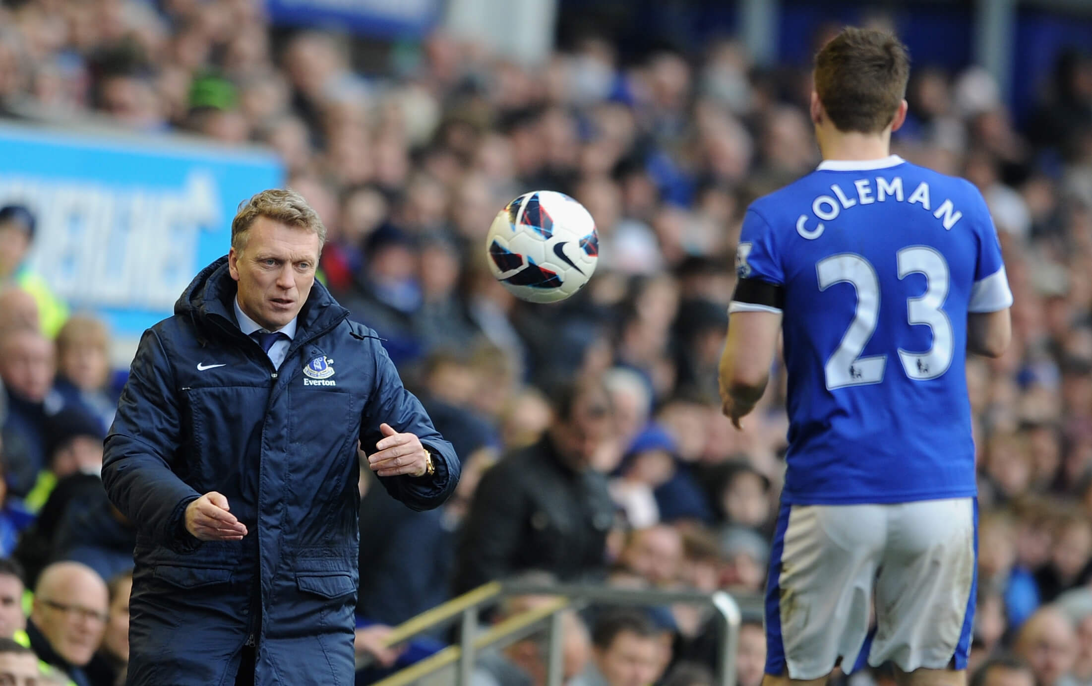 David Moyes tosses the ball to Seamus Coleman during a Premier League game in 2013