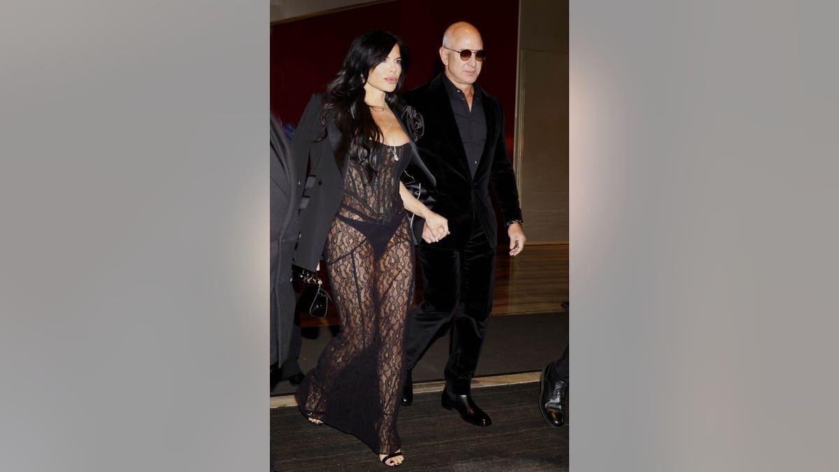 Jeff Bezos and wife Lauren Sanchez walking at Milan Fashion Week menswear event