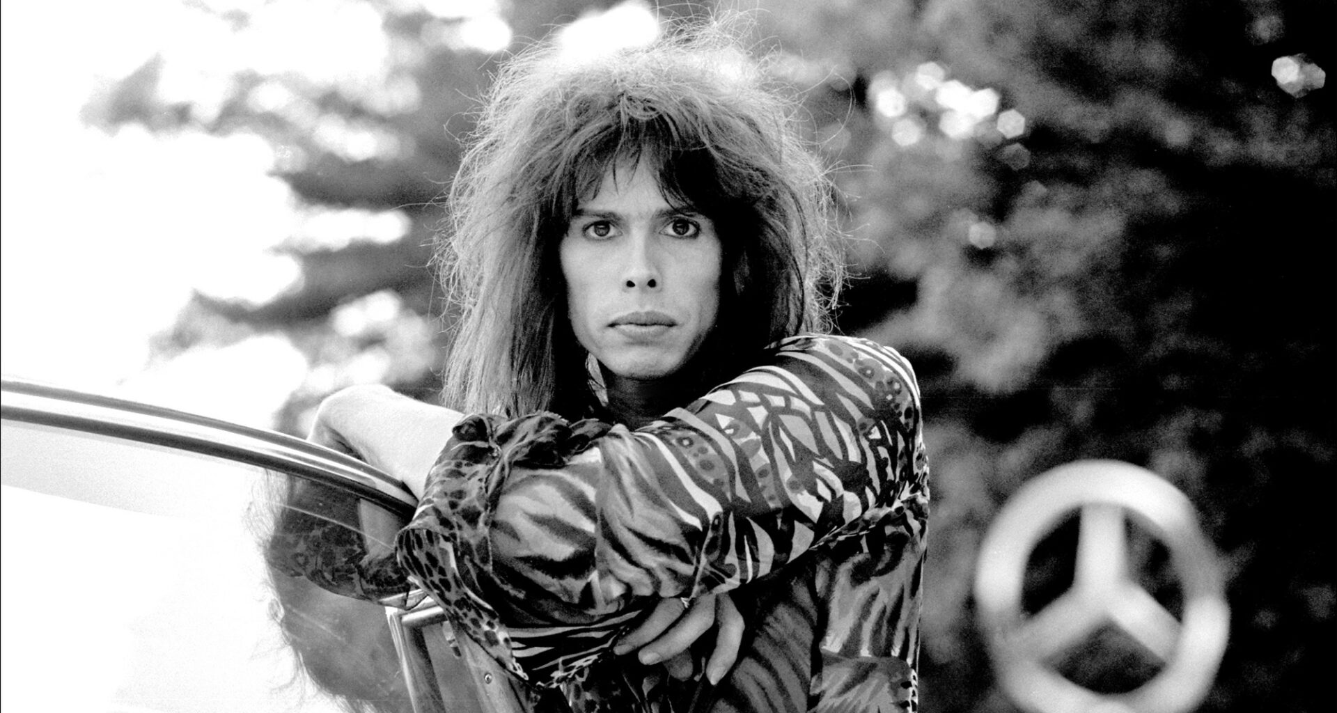 Steven Tyler of rock group Aerosmith in his 1956 Mercedes Benz 220S at Jamaica Pond, Boston MA October 9, 1975
