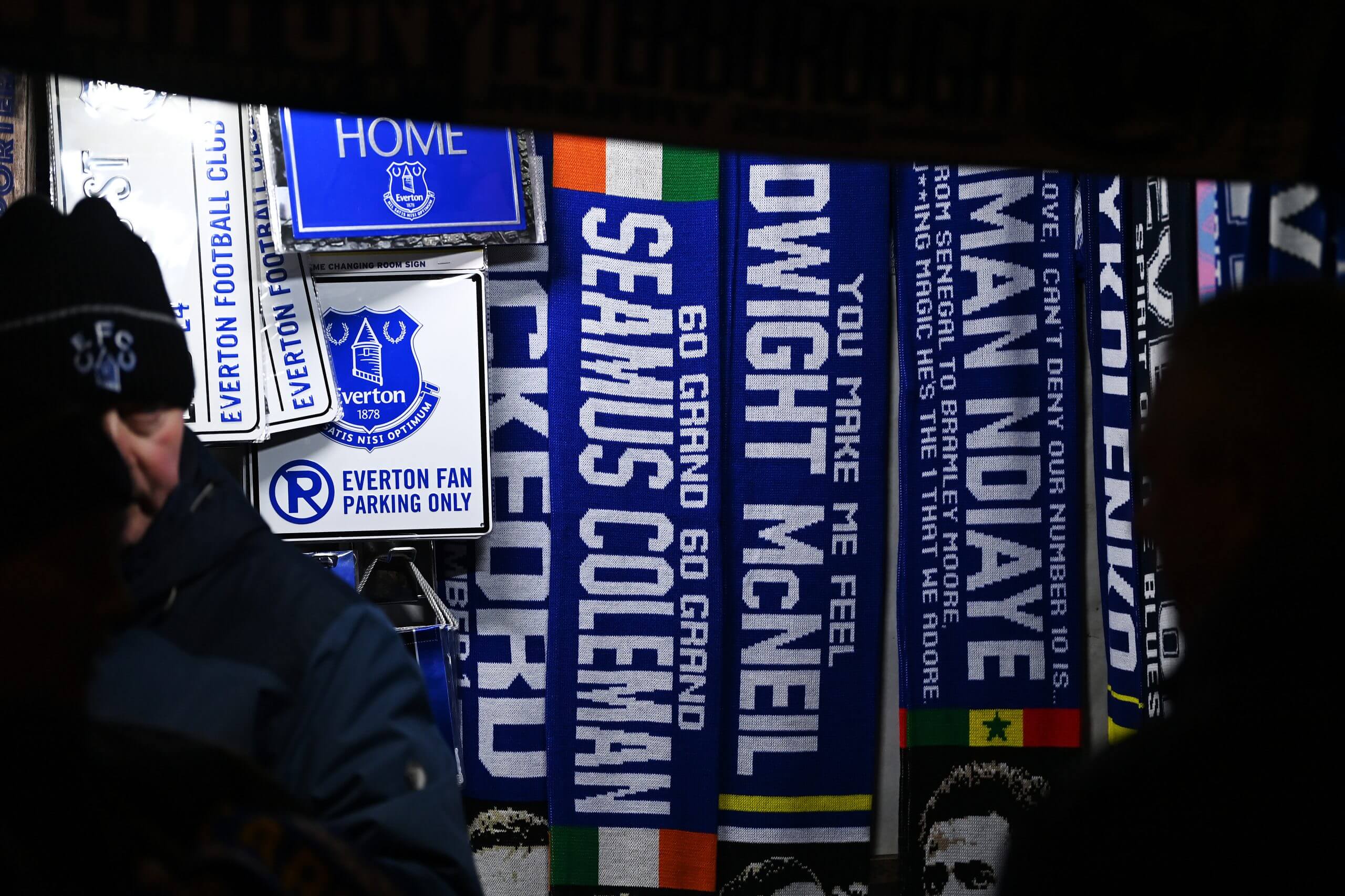 Scarves displaying the names of Everton players for sale outside Goodison Park, with Seamus Coleman in the middle