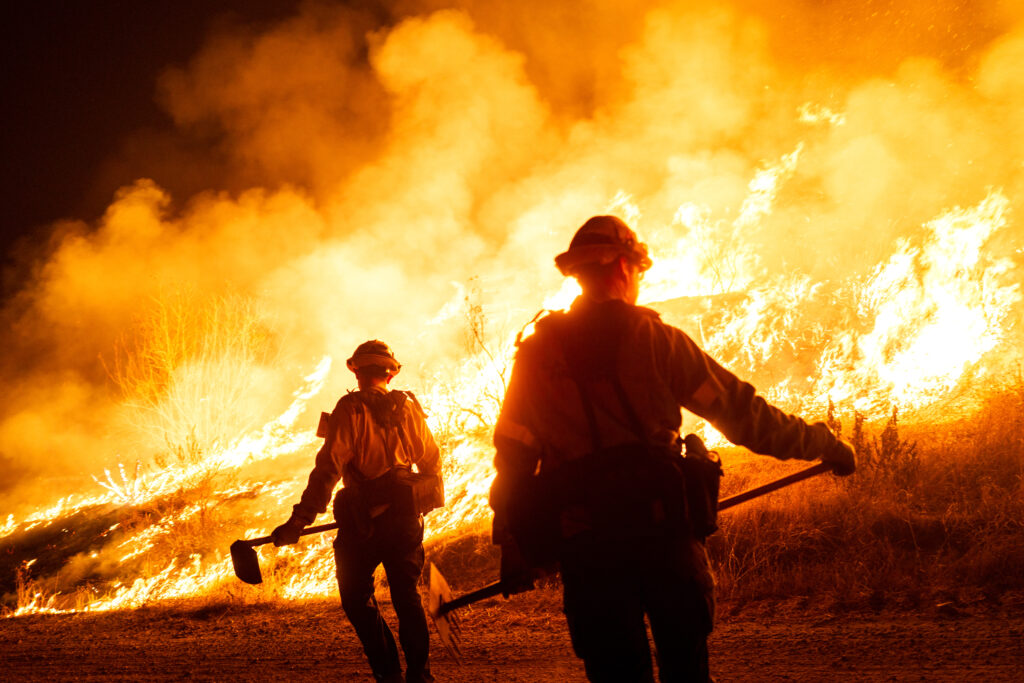 Firefighters work to contain the Hughes Fire as it burns on Jan. 22, 2025, in Castaic, Calif. Credit: Brandon Bell/Getty Images