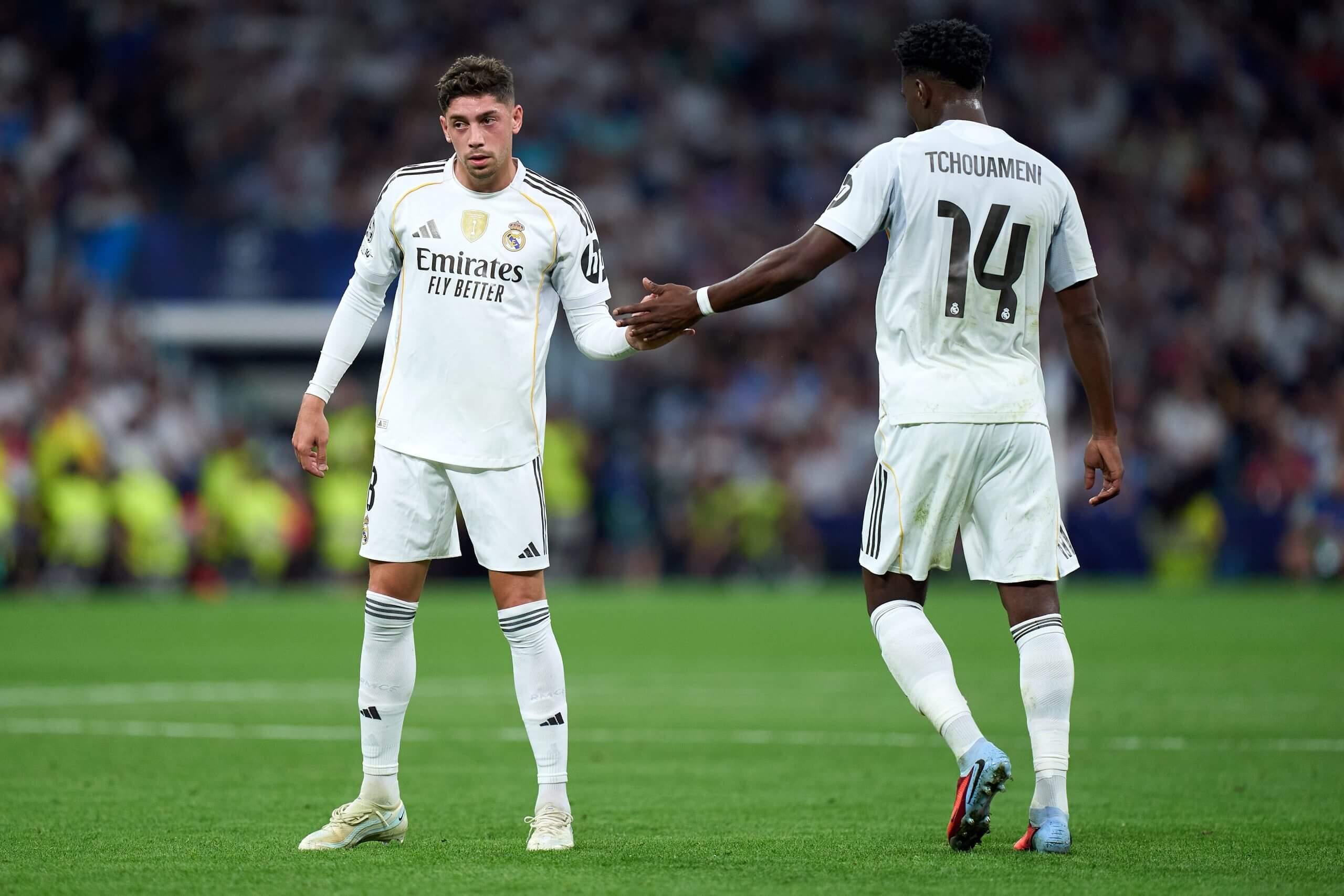 Valverde and Tchouameni exchange a hand slap on the pitch in September 