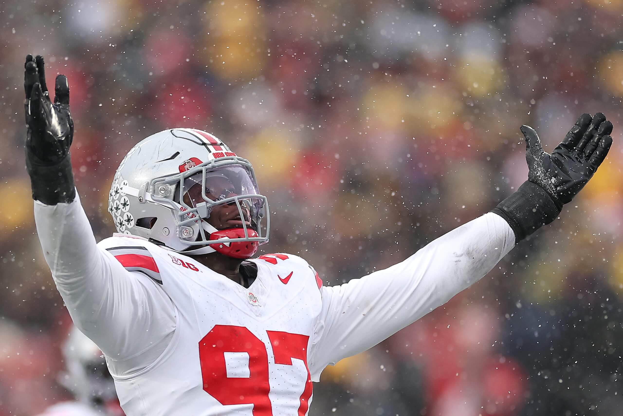 Kenyatta Jackson raises his arms in celebration as it snows at Michigan