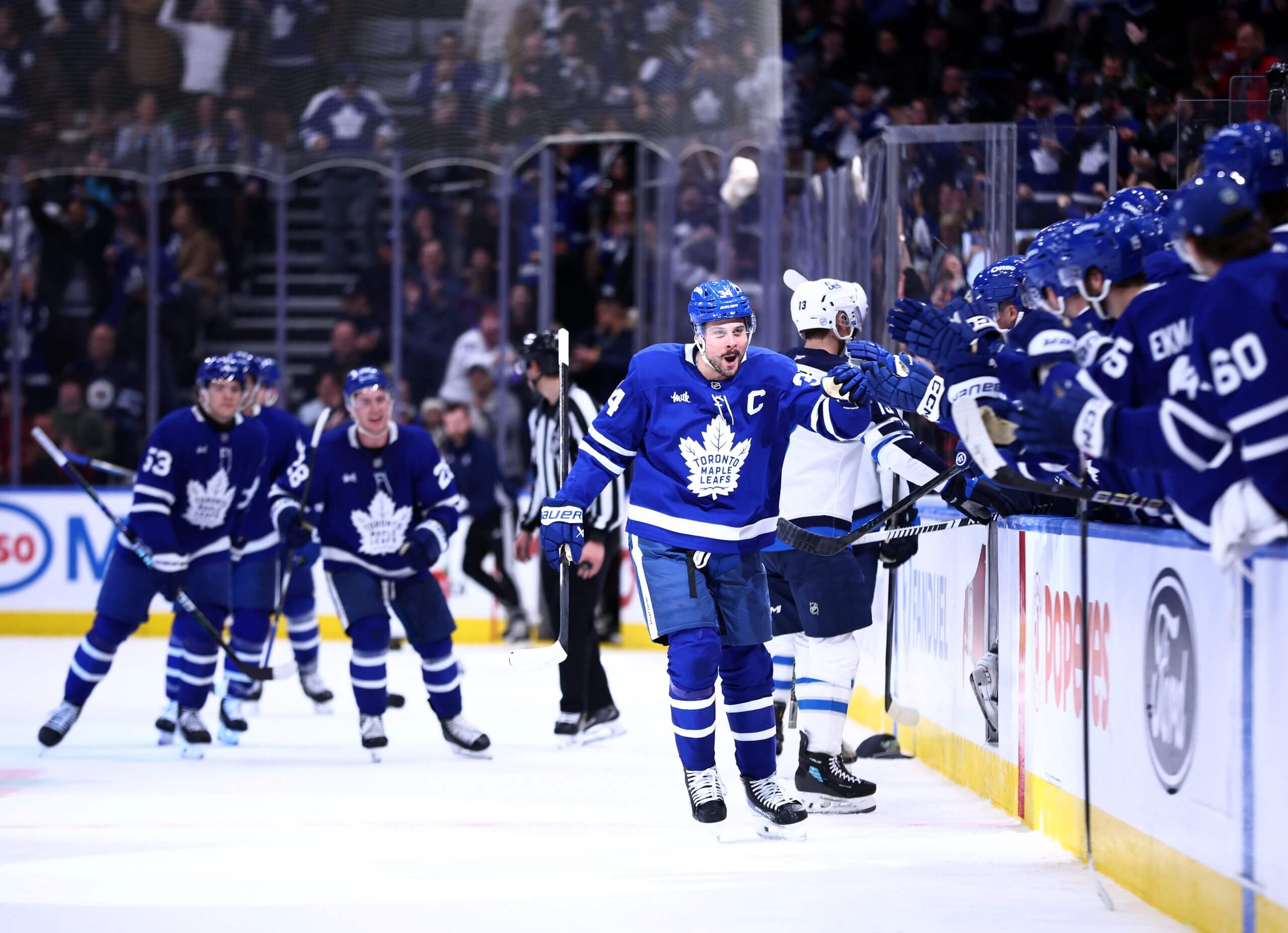Auston Matthews makes his way down the Leafs fist-bump line.