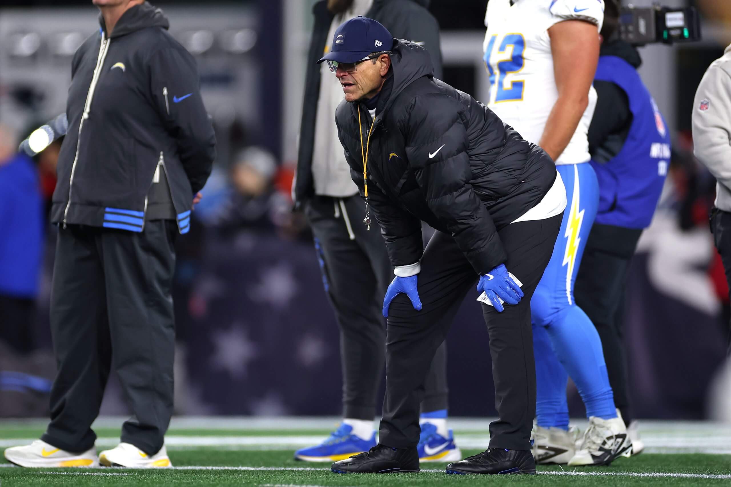 Head coach Jim Harbaugh of the Los Angeles Chargers looks on during warmups before the AFC Wild Card Playoff game against the New England Patriots at Gillette Stadium.
